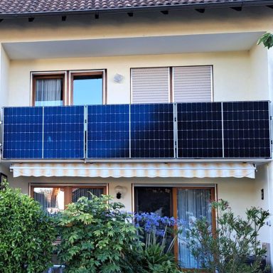Balkonkraftwerk an einem Wohnhaus Balkonkraftwerk mit Solarmodulen an der Balkonbrüstung eines Wohnhauses.